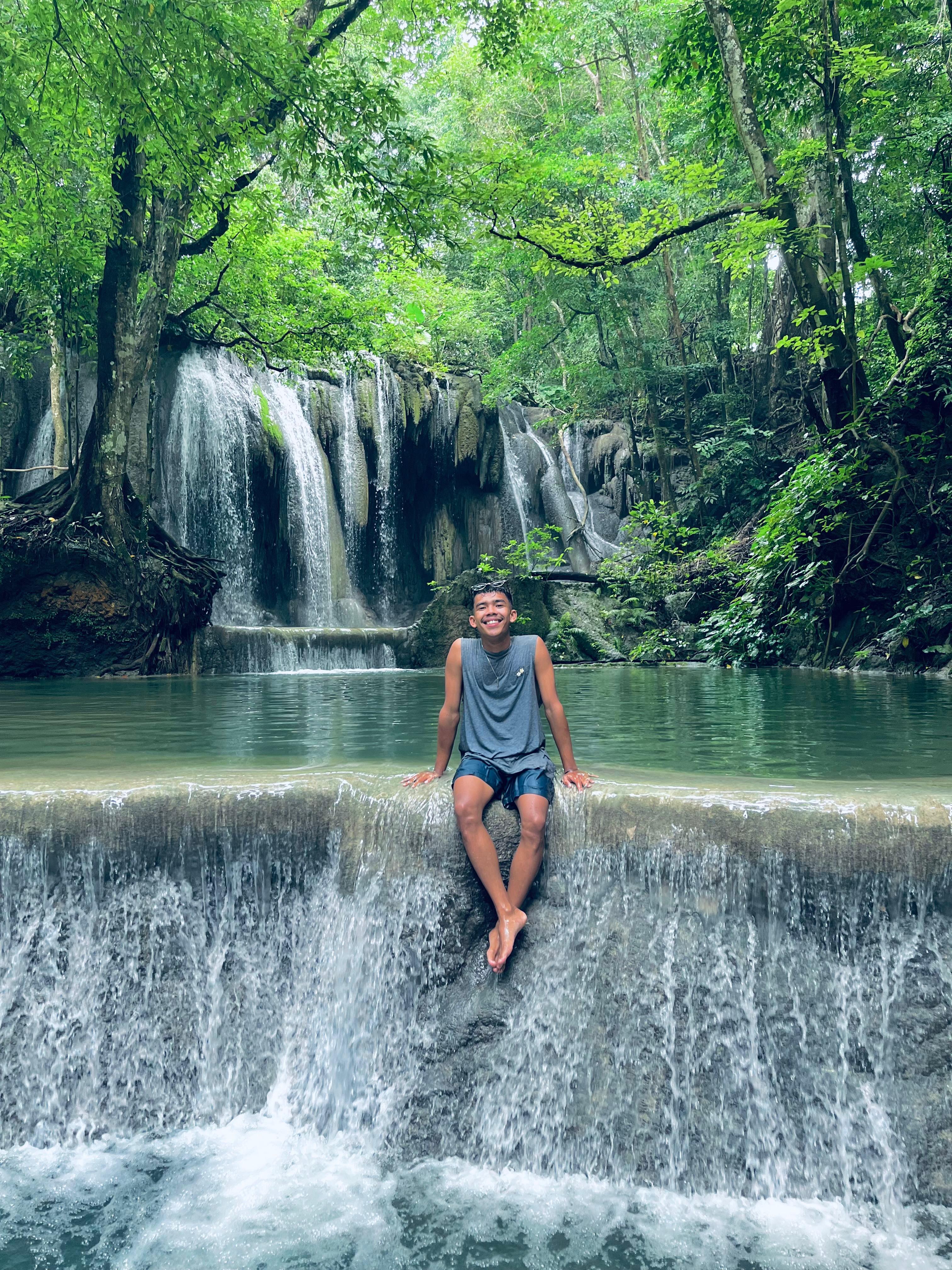 Yan, Tetebatu Fun Tour Guide, at a waterfall in Lombok